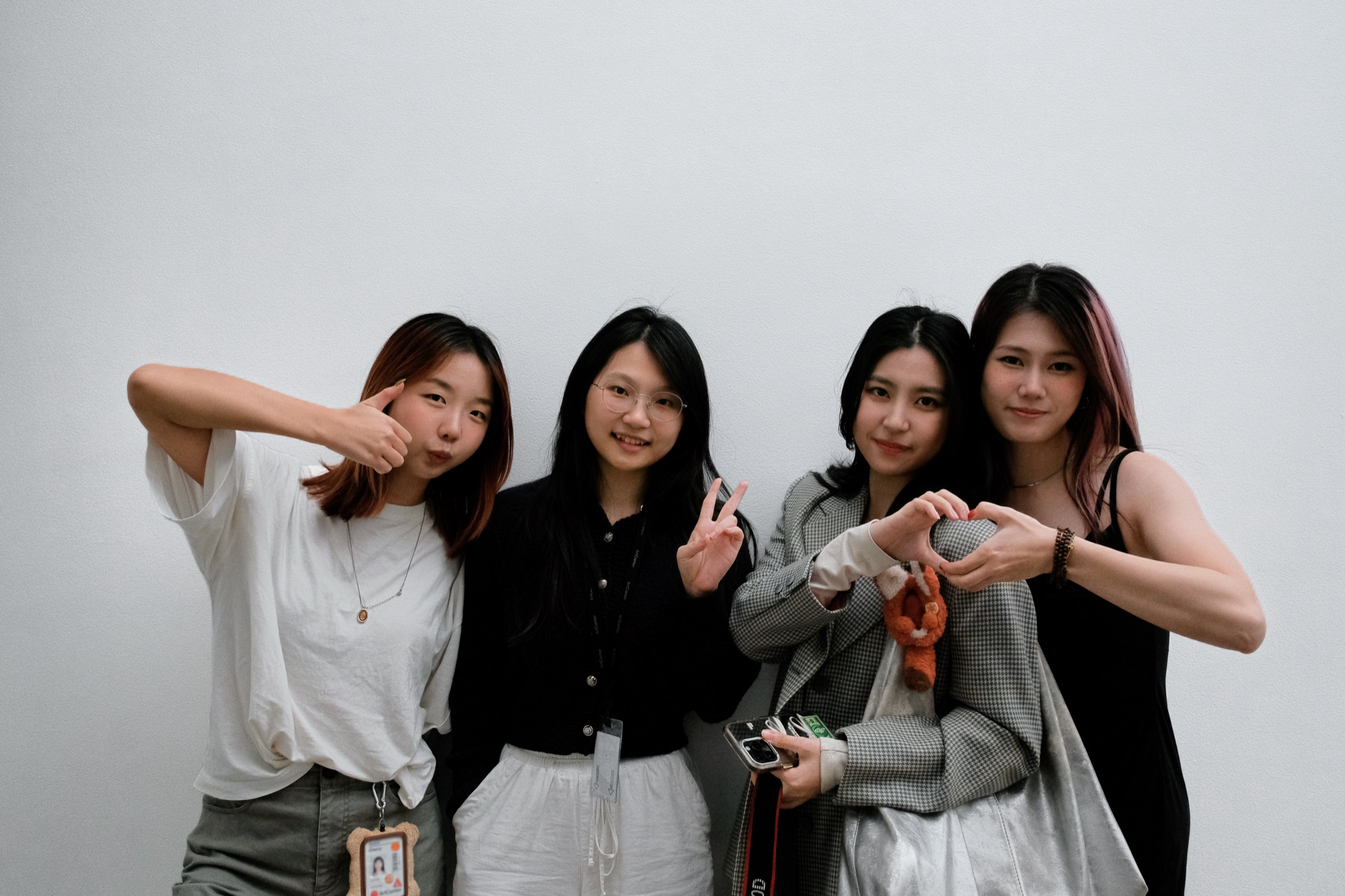 The four of us after the FigBuild deadline — thumbs up, a peace sign, and heart hands.