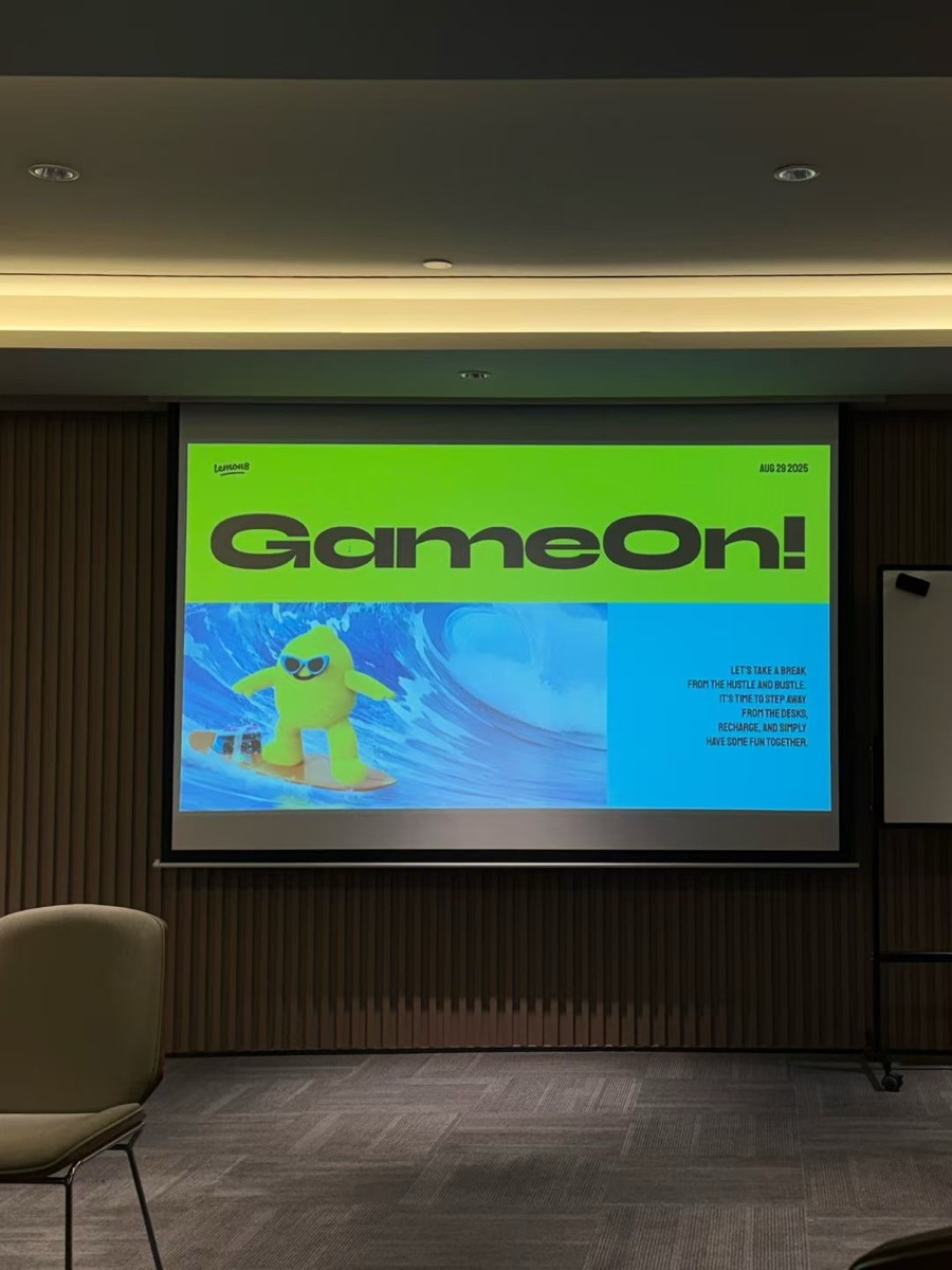 A "GameOn!" deck on the big screen during a team presentation