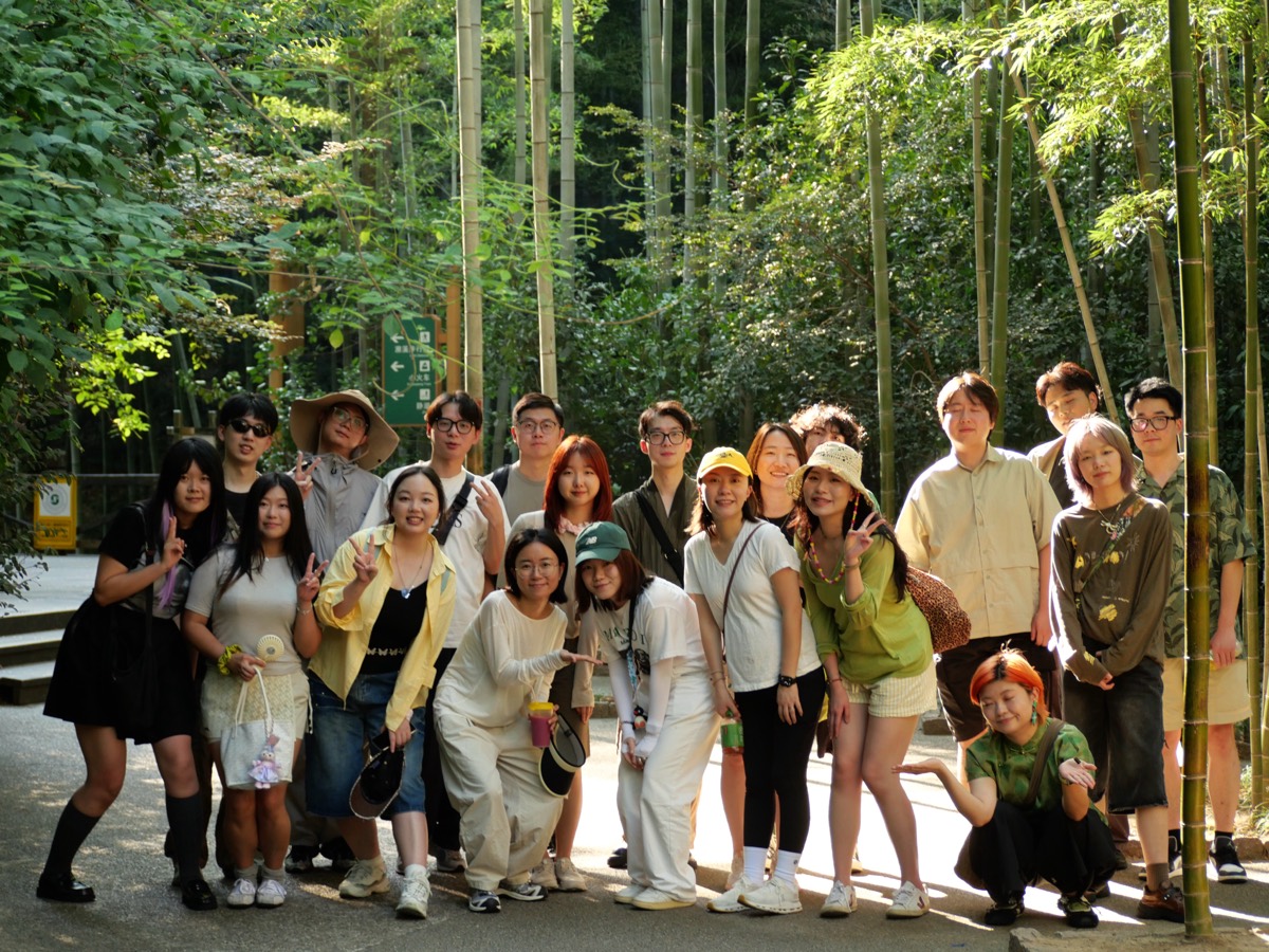 The whole team on an offsite, posing in a bamboo grove